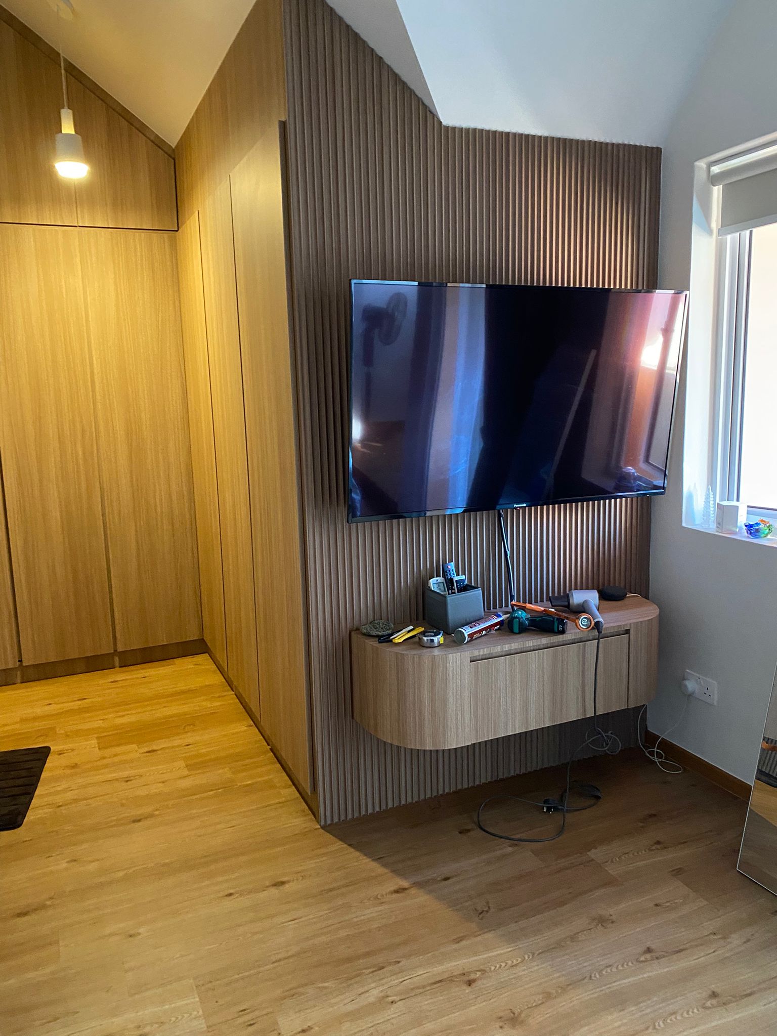 Floating TV console on a fluted wood feature wall