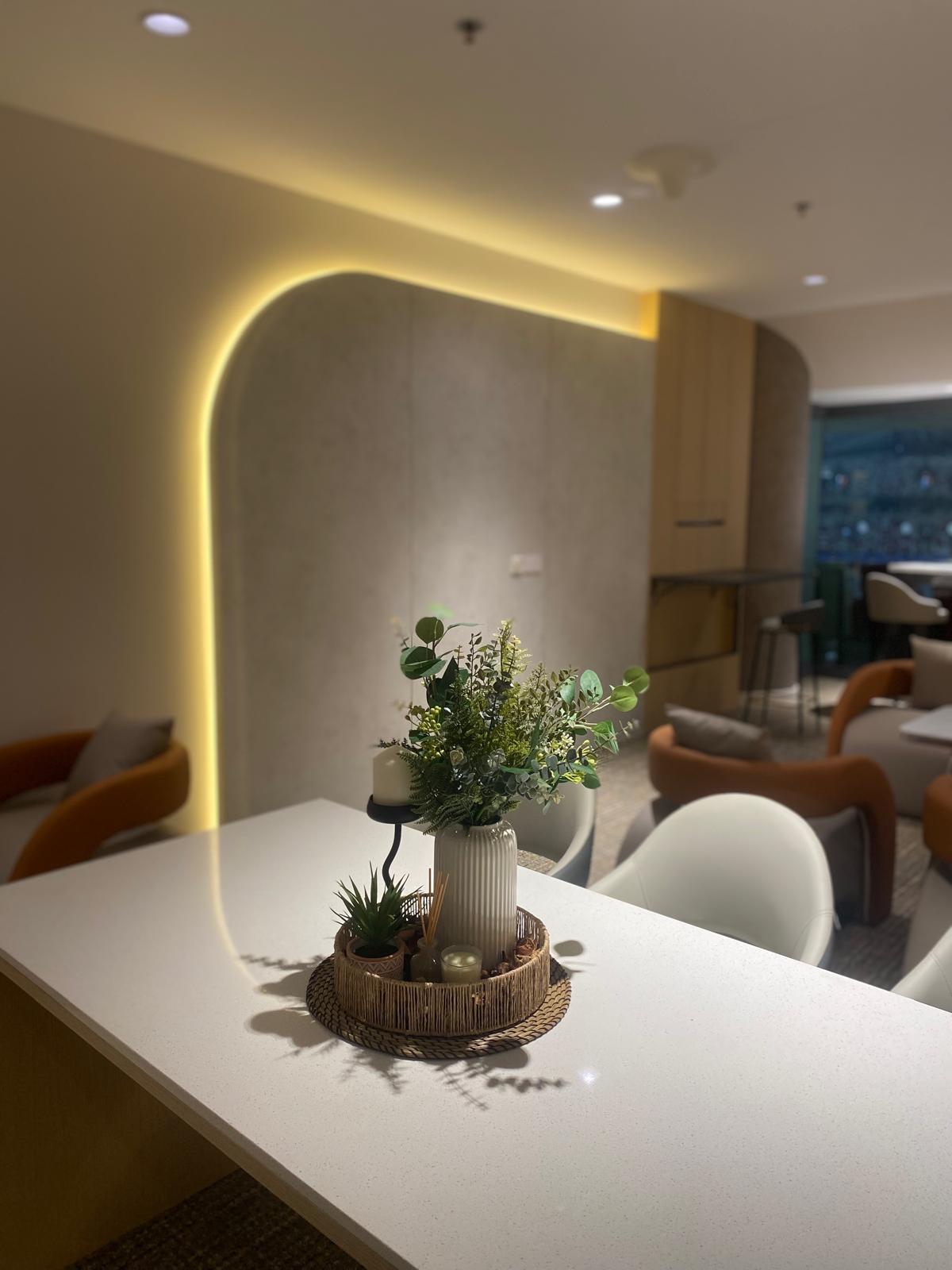 Commercial lounge with an arched cove-lit feature wall