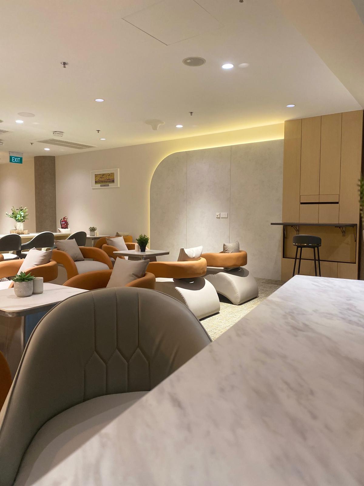 Commercial lounge seating area with warm cove lighting