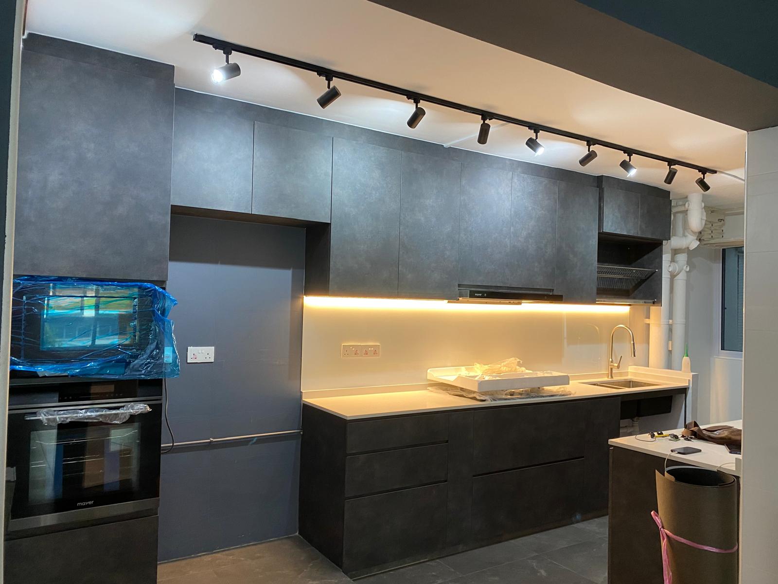 Charcoal stone-finish kitchen with black track lighting